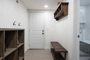 Mudroom with recessed lighting and light tile patterned floors