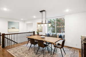 Dining space featuring dark wood-style floors and recessed lighting