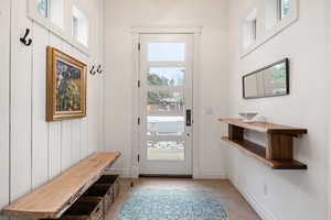 Doorway to outside featuring baseboards