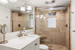 Bathroom with vanity and a stall shower