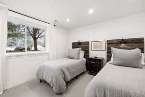 Carpeted bedroom featuring recessed lighting and baseboards