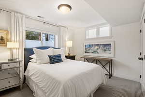 Bedroom featuring carpet flooring and baseboards