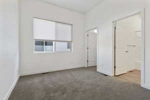 Unfurnished bedroom featuring light colored carpet and baseboards