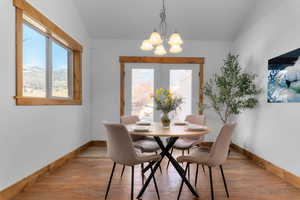 Dining area featuring light wood finished floors, a chandelier, and healthy amount of natural light