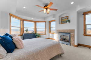 Carpeted bedroom featuring a fireplace, recessed lighting, and a ceiling fan