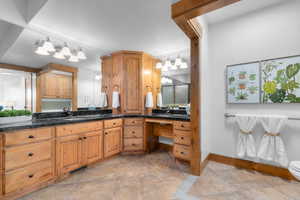 Bathroom featuring vanity and baseboards