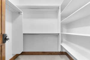 Walk in closet with light carpet