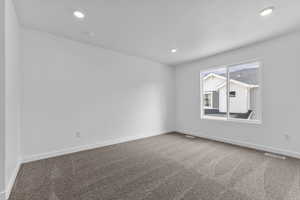 Empty room featuring carpet and recessed lighting