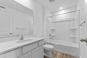 Bathroom featuring vanity, light wood-type flooring, and bathtub / shower combination