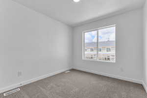 Empty room with baseboards and carpet floors
