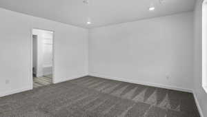 Empty room with carpet floors and recessed lighting