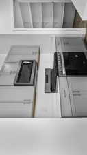 Kitchen with white cabinetry, light countertops, and stainless steel microwave