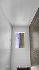 Unfurnished room featuring wood walls