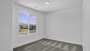 Carpeted empty room with baseboards and a mountain view