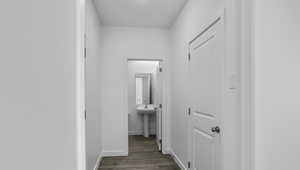 Hallway with baseboards and wood finished floors