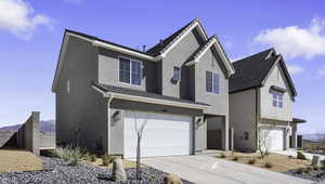 Traditional-style home with an attached garage, a mountain view, concrete driveway, and stucco siding
