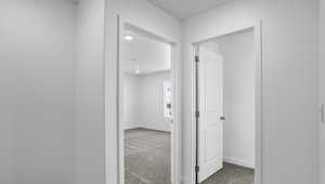 Hall featuring light carpet and recessed lighting