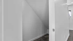 Interior space featuring baseboards and carpet