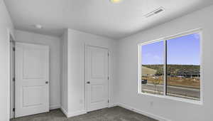 Unfurnished bedroom featuring carpet and baseboards