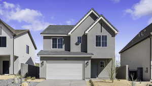 Traditional home featuring an attached garage, concrete driveway, a tile roof, and stucco siding