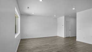Empty room with light wood-style floors, a textured ceiling, and recessed lighting