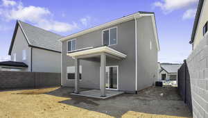 Rear view of house with a patio, a fenced backyard, and stucco siding