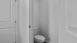 Bathroom featuring toilet and baseboards