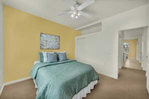 Bedroom featuring a closet, carpet floors, and ceiling fan