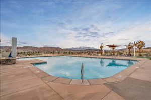 Community pool with a mountain view and a patio area