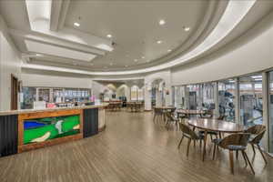 Reception featuring recessed lighting, a tray ceiling, and arched walkways