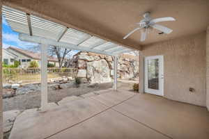 View of patio featuring a pergola and a ceiling fan