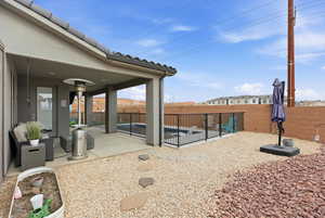 Fenced backyard with a patio