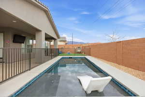 View of pool with a fenced backyard and patio surround