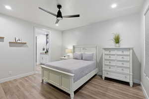 Bedroom featuring light wood finished floors, ceiling fan, recessed lighting, and connected bathroom