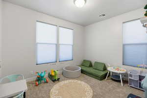 Playroom with carpet and baseboards