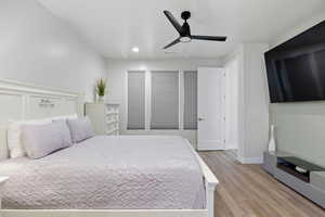 Bedroom with light wood-type flooring, a ceiling fan, and recessed lighting