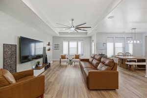 Living room featuring light wood finished floors and ceiling fan