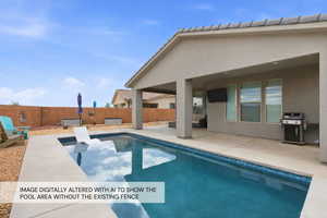 View of pool featuring patio surround, a grill, and a fenced backyard