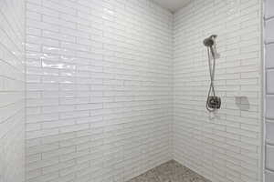 Bathroom featuring tiled shower