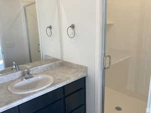 Full bathroom with a shower stall and vanity