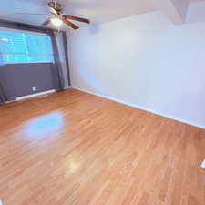 Unfurnished room featuring light wood-style flooring and a ceiling fan