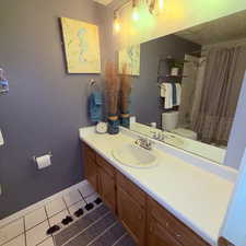 Bathroom with vanity and light tile patterned flooring