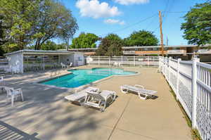 Community pool featuring a patio