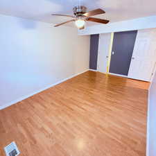 Unfurnished room featuring light wood-style floors and a ceiling fan