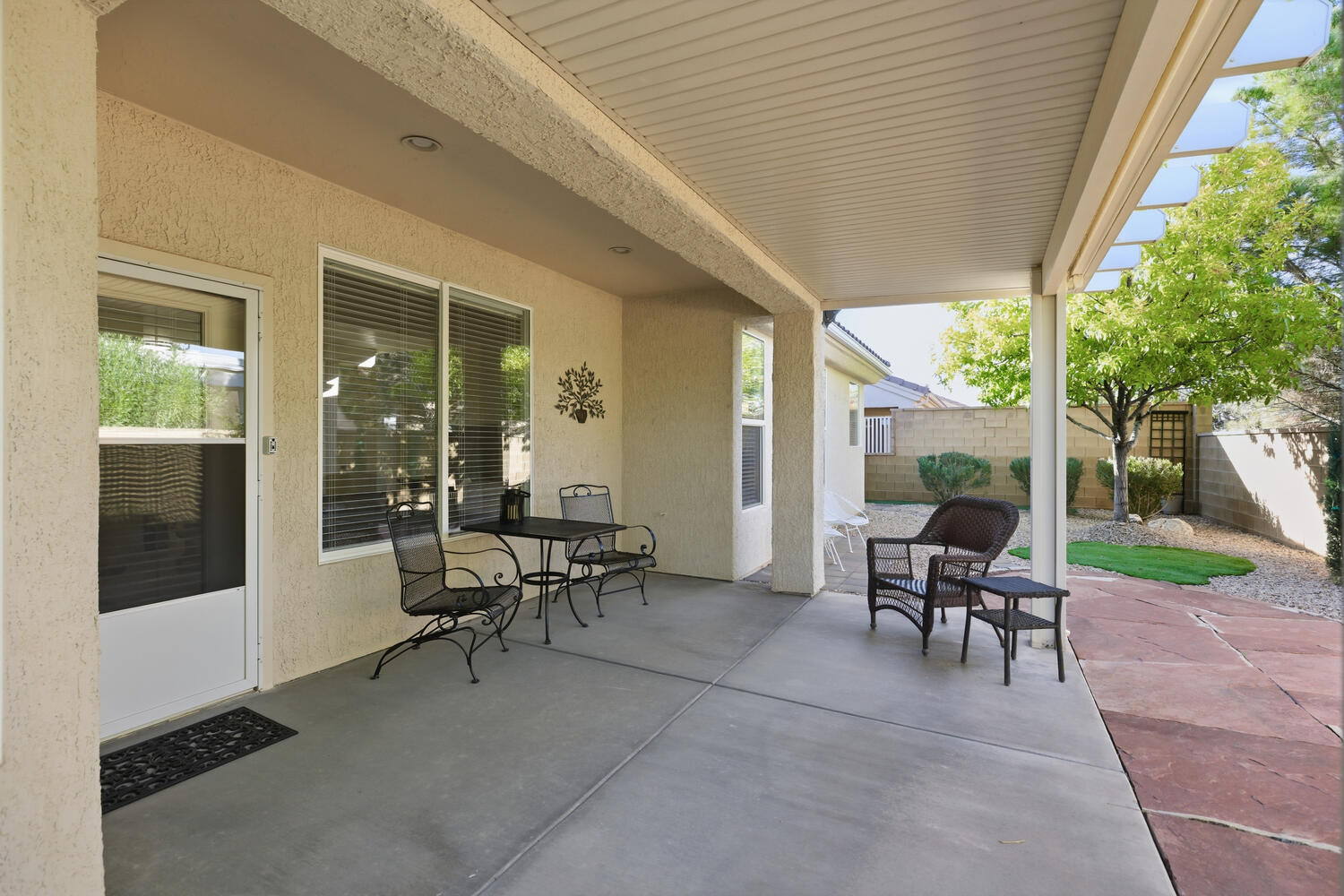 Fenced backyard with a patio area and outdoor dining area