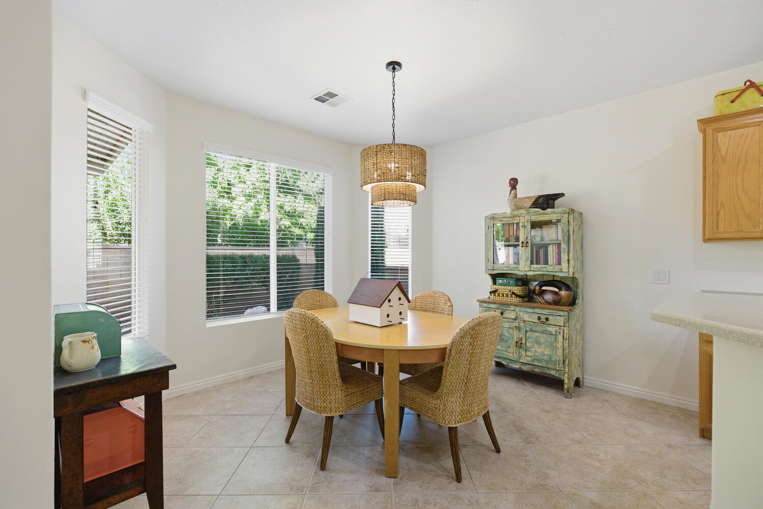 Dining space with light tile patterned floors and baseboards