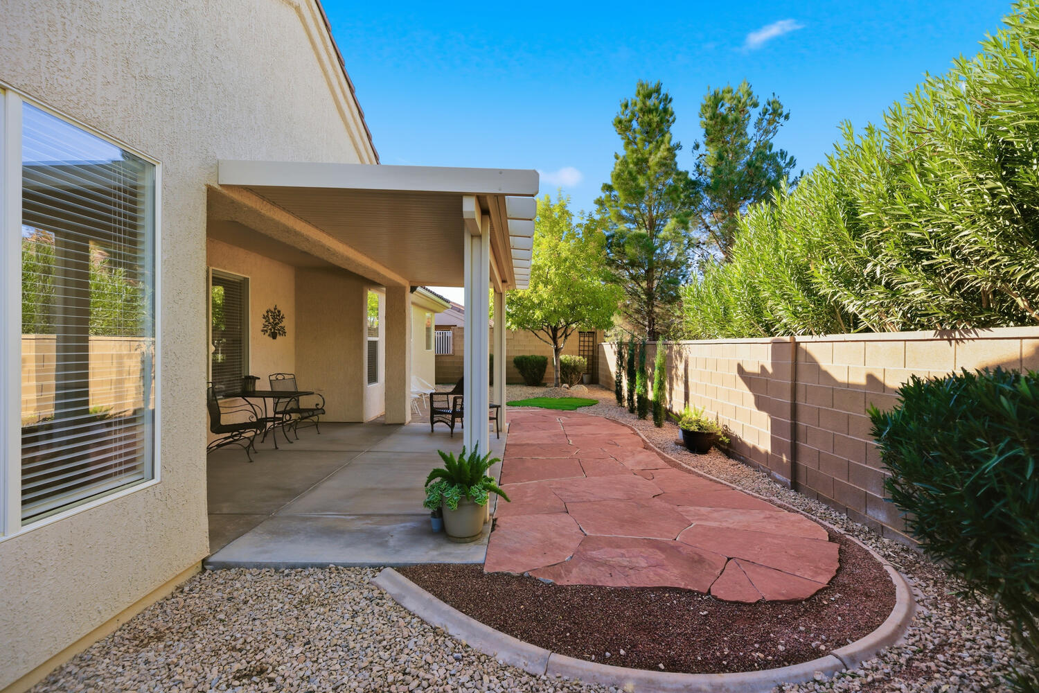 Fenced backyard with a patio