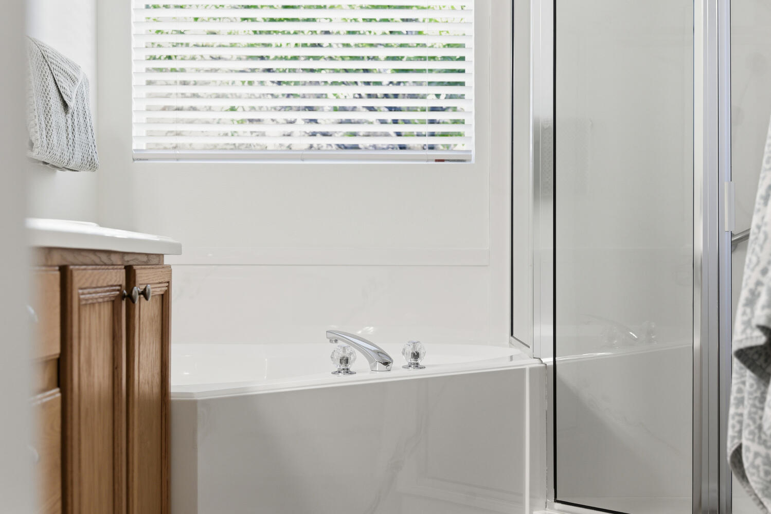 Bathroom featuring a garden tub and a shower stall