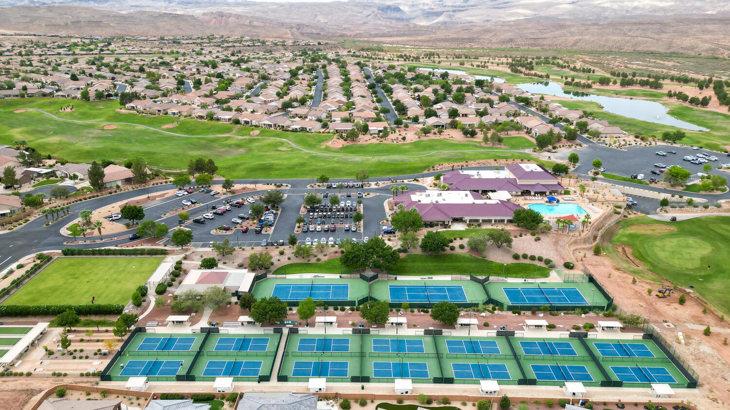Aerial view of property's location with nearby suburban area and a water and mountain view
