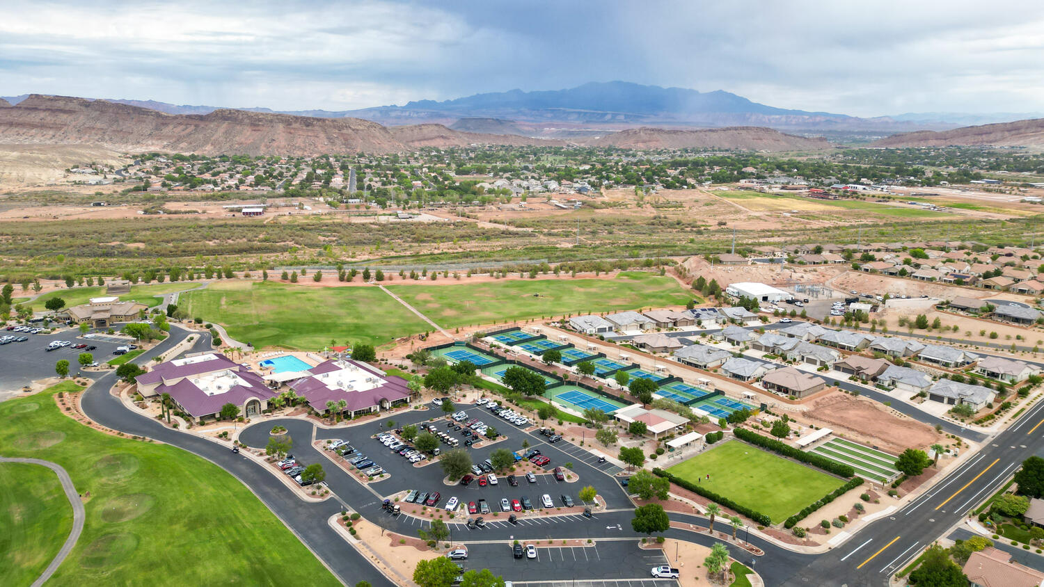 Aerial view of residential area with mountains and a golf club